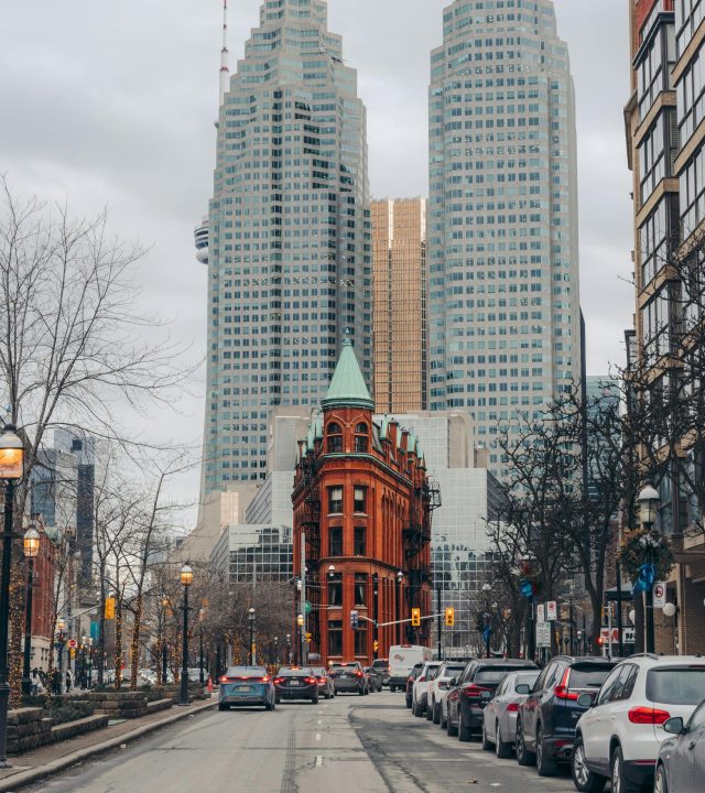 View of the iconic Gooderham Building amidst Toronto's skyscrapers, capturing urban city life.
